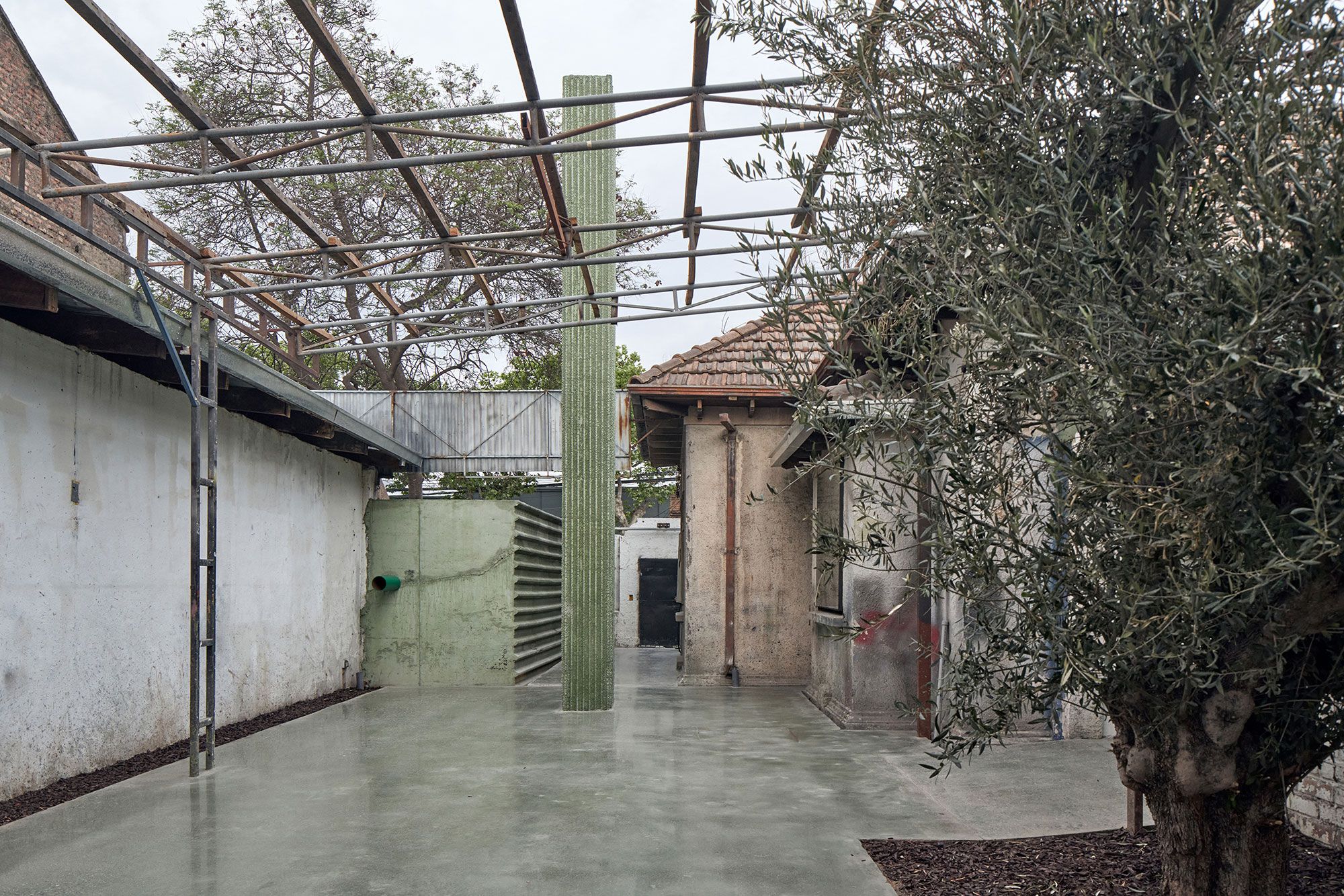 The green column, between the original house and the olive tree.