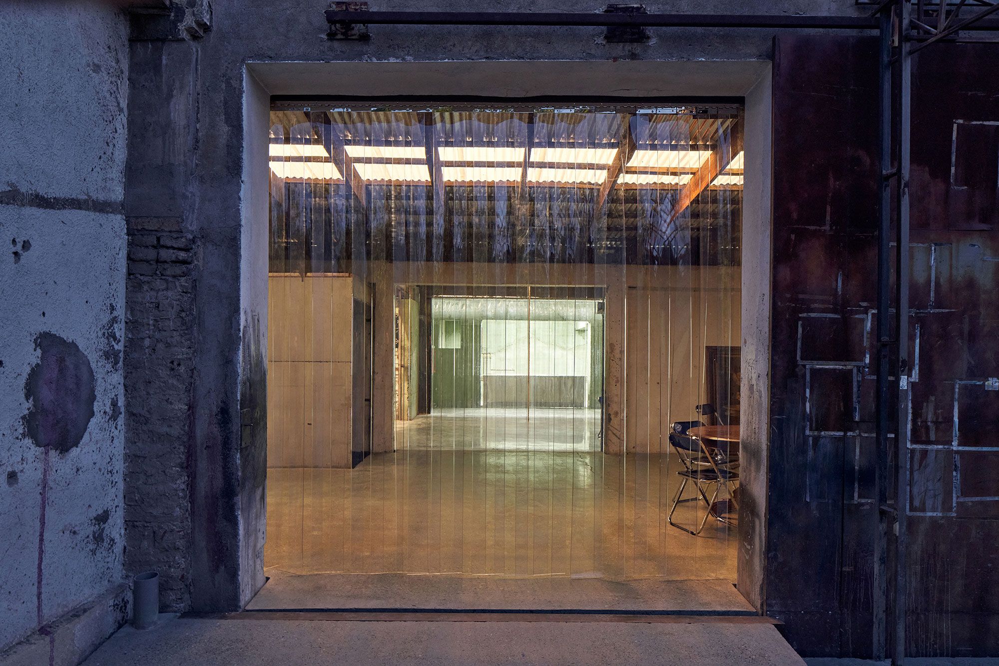 At night, the hall glows behind the curtain.